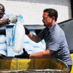 James Fitzgerald and Brandon Corey load up the ice bins at Kangaroo Express on Va. 610 in North Stafford. They’ve had to use a bigger truck to keep up with demand that has more than doubled due to the unusually hot weather. (Mary Davidson)