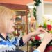 Janet Dwyer, a floral designer at Achara Florist in Aquia Park in Stafford, was excited about a very special request she received from a customer. The customer brought in a diamond ring that he wanted hidden in a bouquet of flowers and delivered to his sweetheart. (Photo: Mary Davidson/PotomacLocal.com)