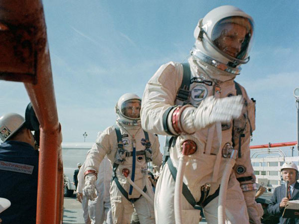Commander Neil Armstrong (right) and pilot David R. Scott prepare to board the Gemini-Titan VIII. Gemini VIII successfully launched at 11:41 a.m. EST, March 16, 1966. The mission conducted the first docking of two spacecraft in orbit and landed safely back on Earth after an emergency abort. (Image Credit: NASA)