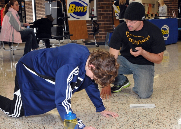 011912 Fitness 3 Zeb Cottongim, 13, of Stafford, gets a bit of personal training from Mike Foster during the fitness challenge. (Photo: Mary Davidson/PotomacLocal.com)