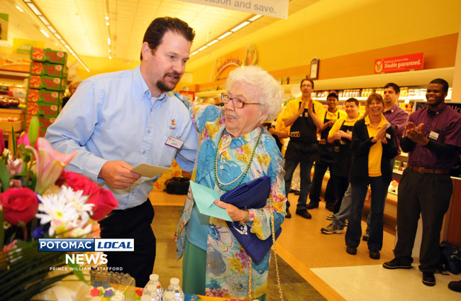 Giant store Manager Larry Merritt gives Doris Woodring a hug  at a surprise birthday party the store held in her honor. [Mary Davidson / Potomac Local News]