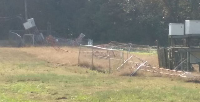 A view of one of the collapsed towers and damage to fencing.